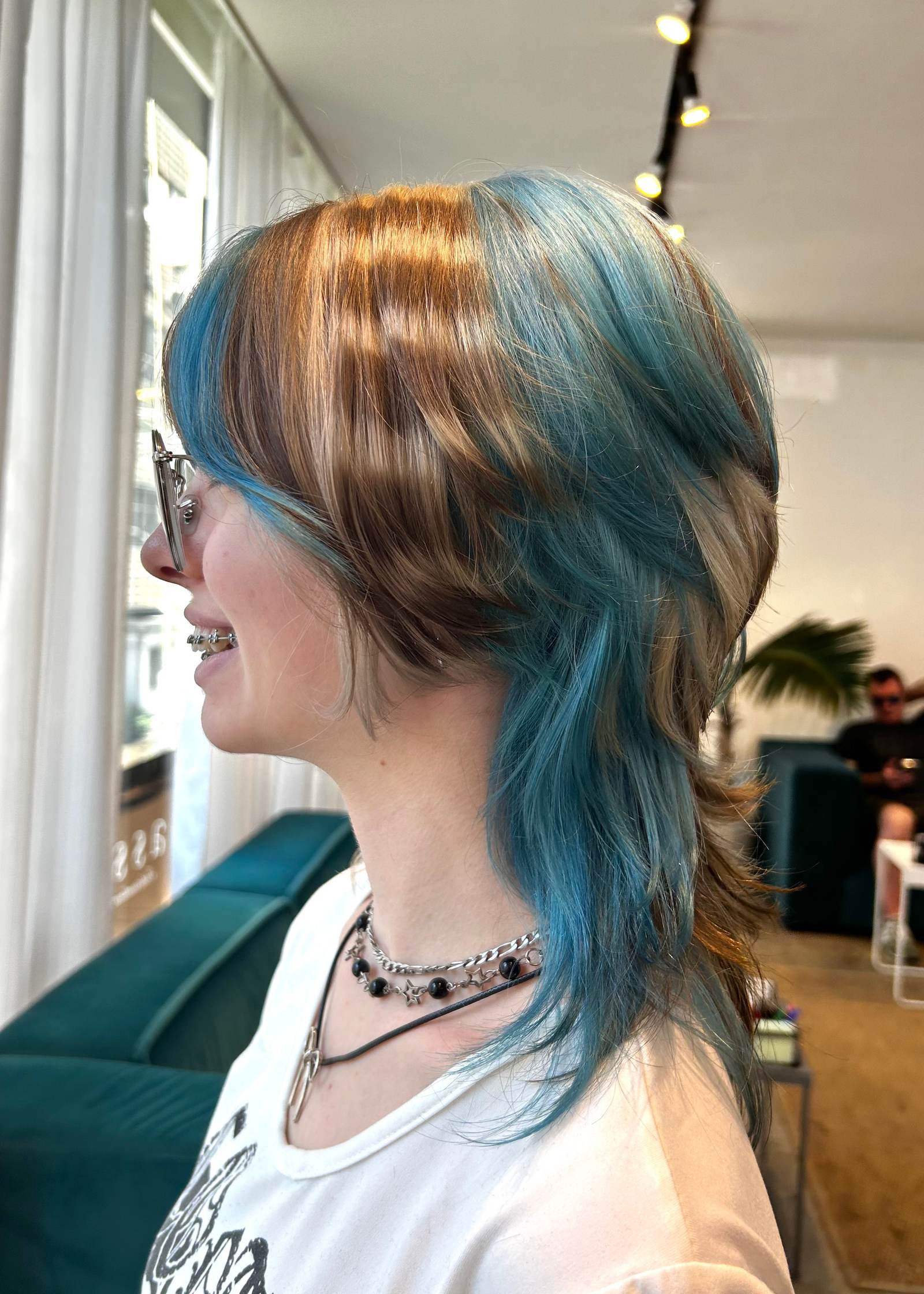 High-contrast blonde and dark brown raccoon tail stripes on a graphic face framing.
